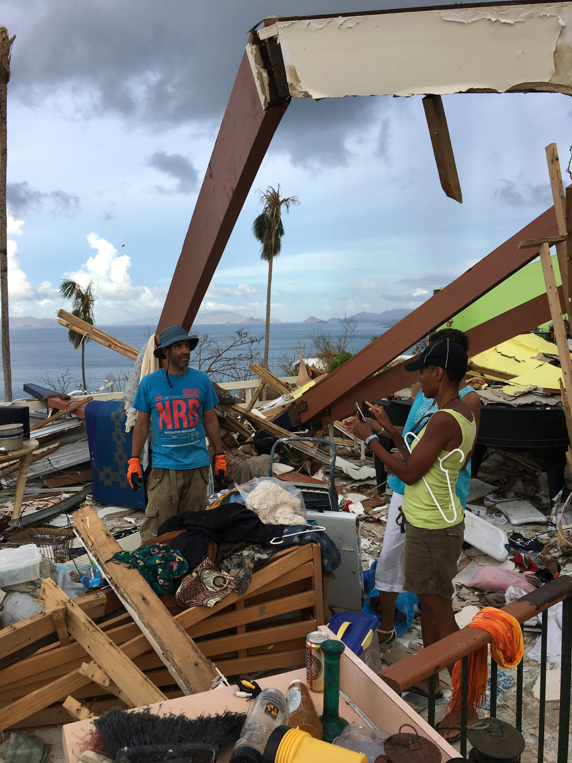 Os voluntários limpam os restos das casas após o desastre natural.