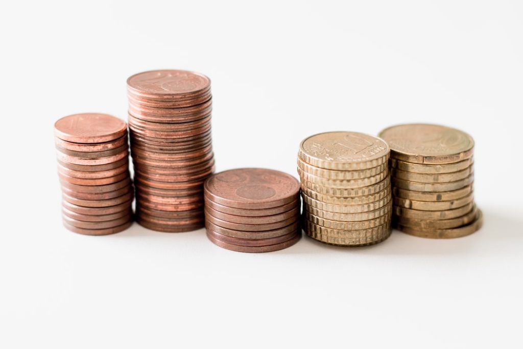 Five stacks of coins against a white background