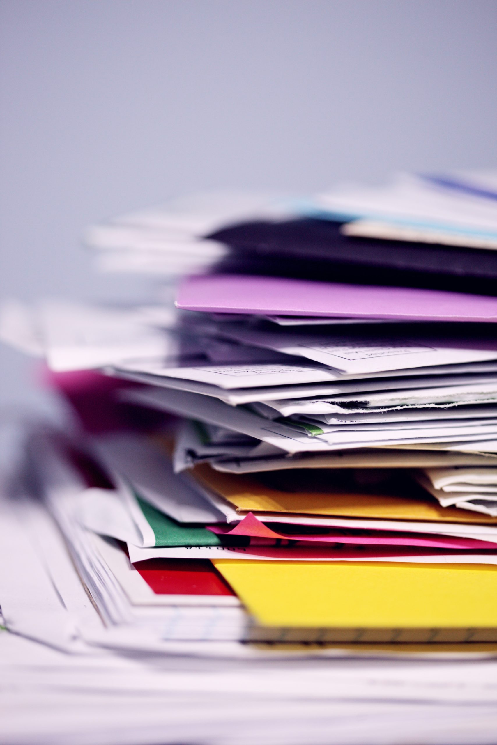 A stack of colorful folders and papers depict many resources.