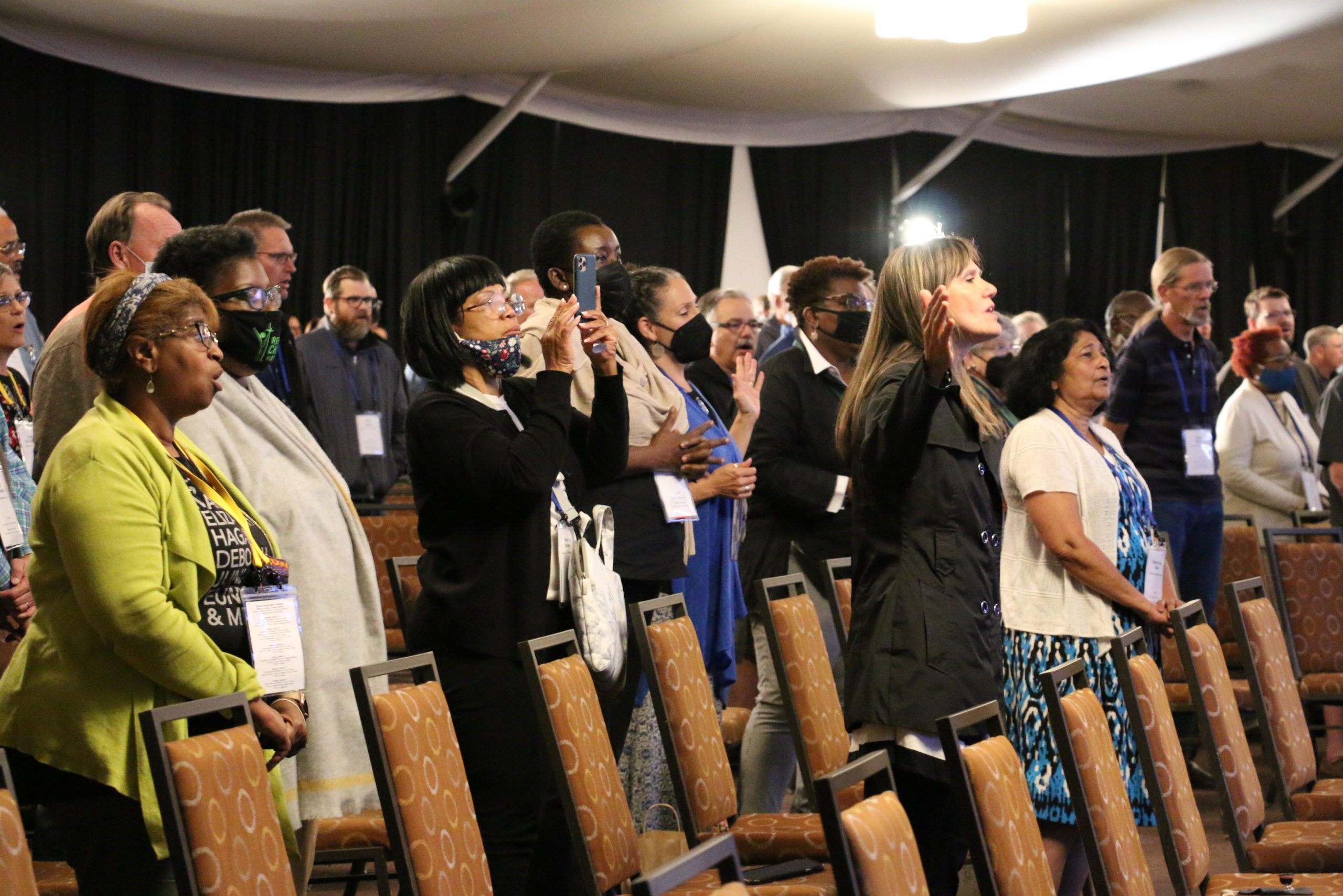 Los delegados alaban a Dios durante el culto