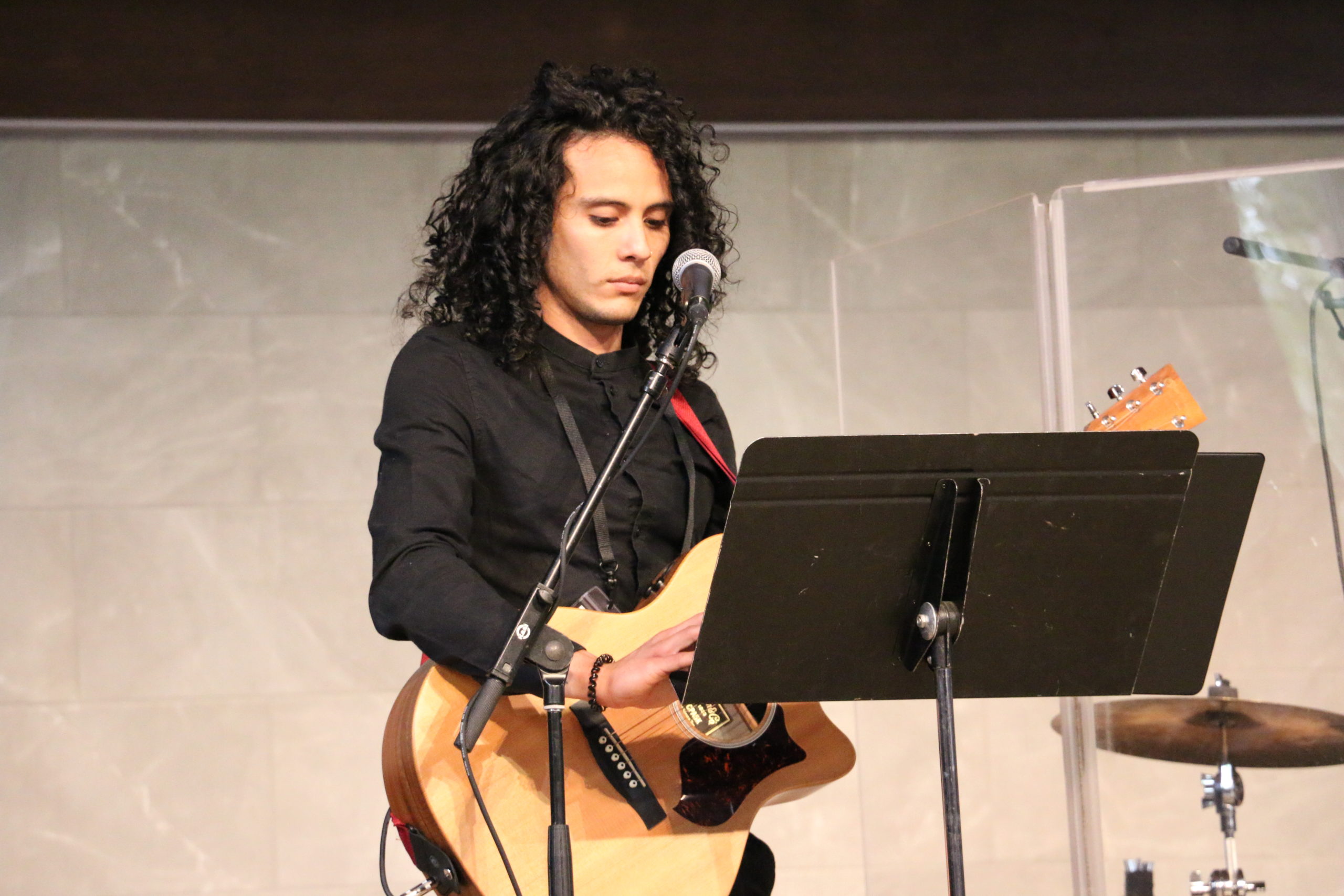 Guy playing guitar during worship